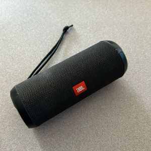 JBL Flip 3 Portable Speaker with charger cord.